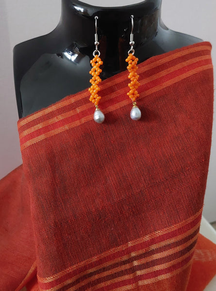 Long simple orange earring with gray dangling teardrop pearl